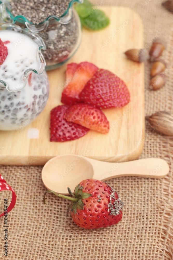 Chia seeds with milk and fresh strawberries.