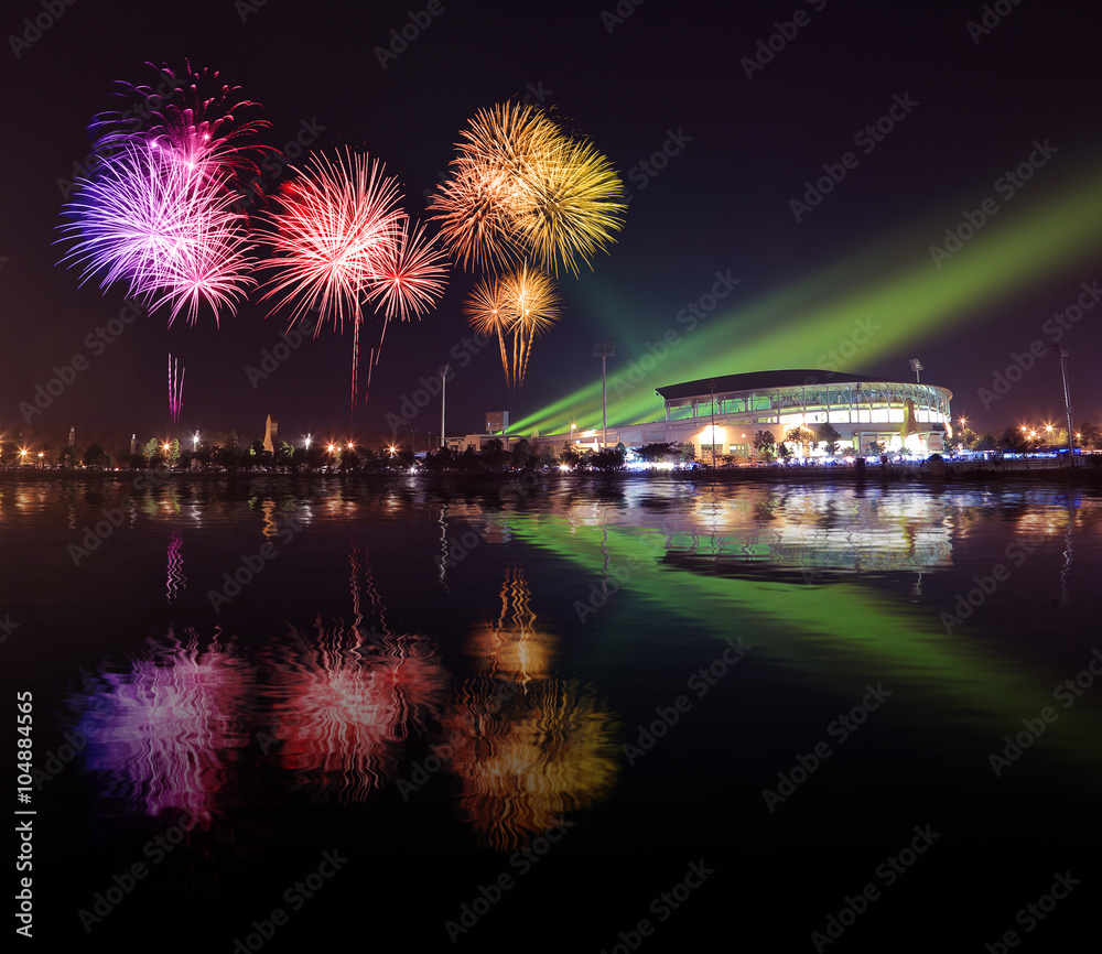 beautiful firework over stadium with water reflection