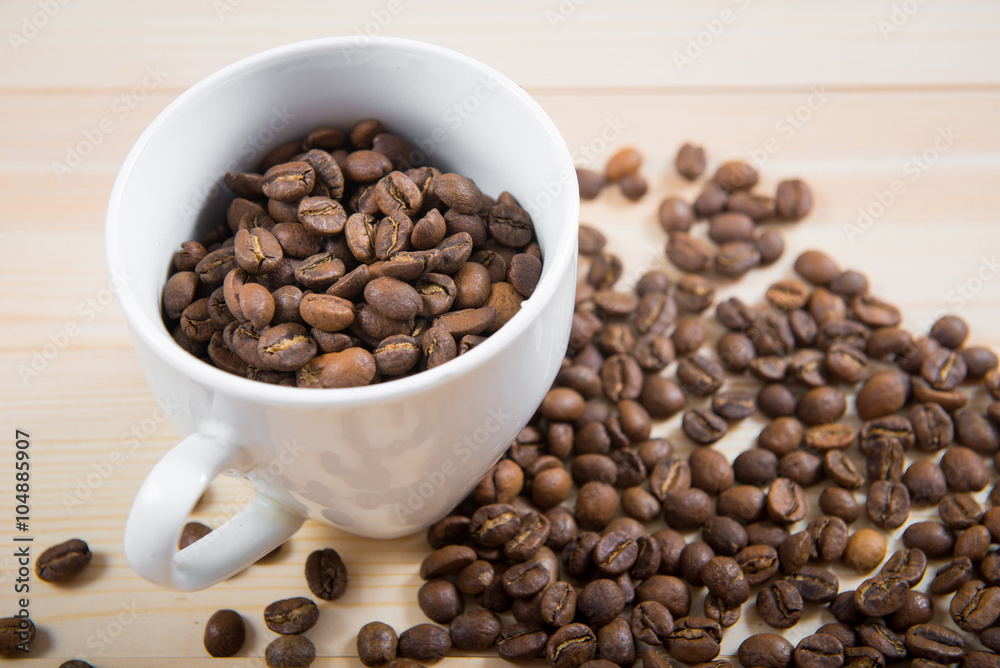 coffee beans in cup. Coffee cup and coffee beans on wooden background. coffee with cinnamon, coffee with additives
coffee beans in cup. Coffee cup and coffee beans on wooden background. coffee with cinnamon, coffee with additives