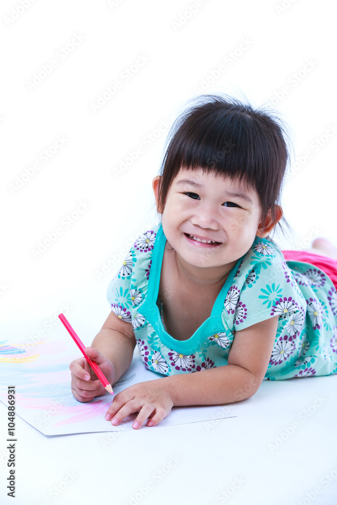 Child lie on the floor drawing on paper and smiling. On white background. Child lie on the floor drawing on paper and smiling. On white background.