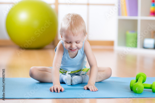 happy kid boy doing gymnastics