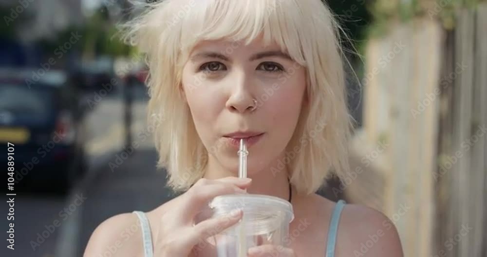 Slow Motion Portrait of happy beautiful caucasian woman drinking juice