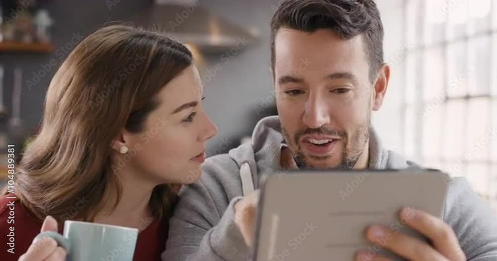 Happy couple using digital tablet at home spending time together Happy couple using digital tablet at home spending time together