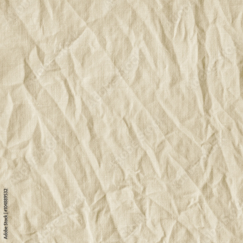 Beige canvas with delicate striped pattern, crumpled.