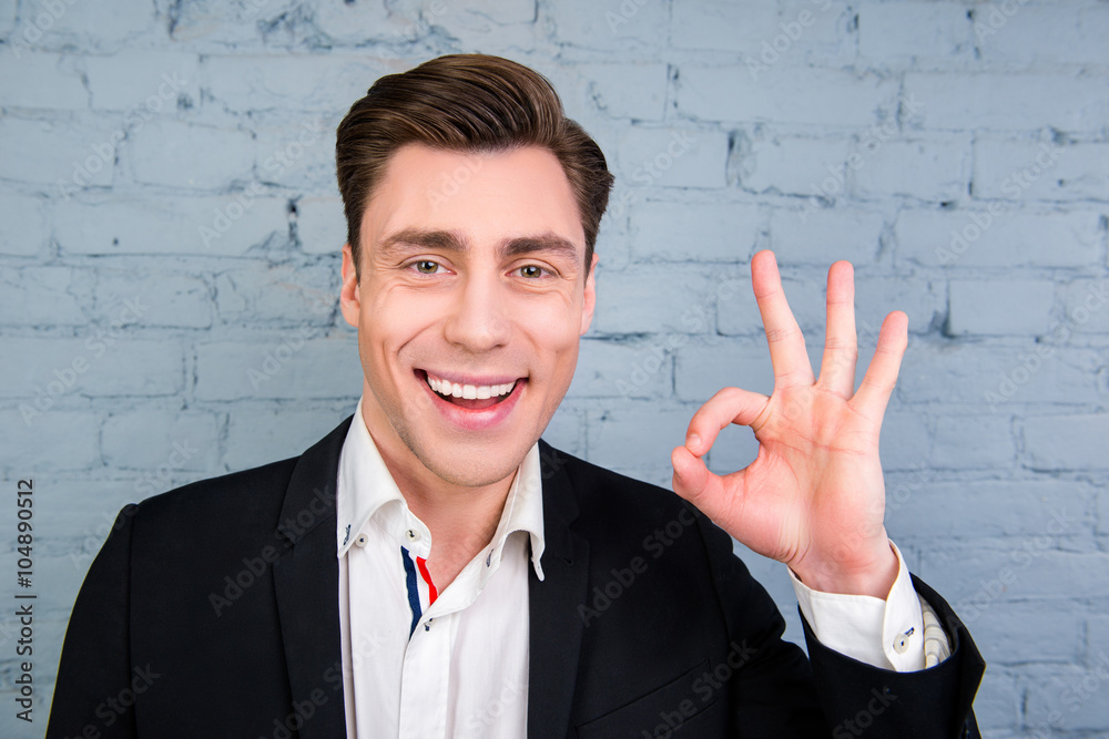 Happy smiling man in black jacket gesturing Happy smiling man in black jacket gesturing
