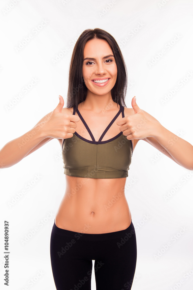 Pretty healthy young brunette showing thumbs up Pretty healthy young brunette showing thumbs up