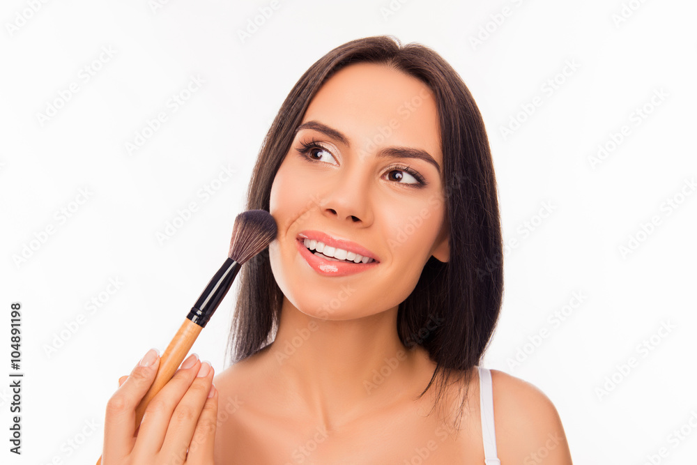 Beautiful young woman applying powder with makeup's brush Beautiful young woman applying powder with makeup's brush