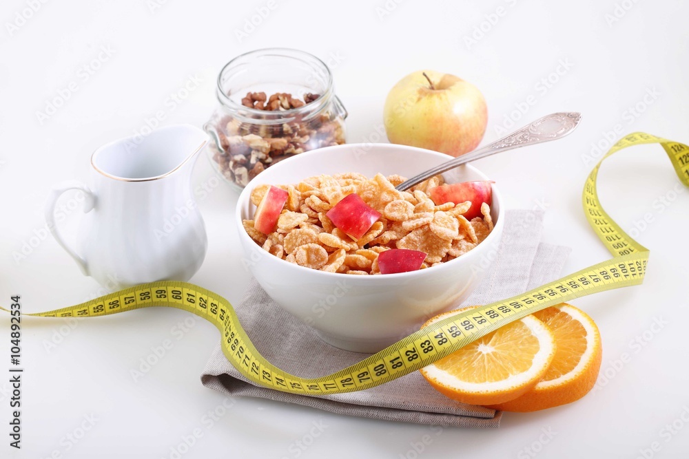 muesli with Apple, orange and measuring tape on white background muesli with Apple, orange and measuring tape on white background