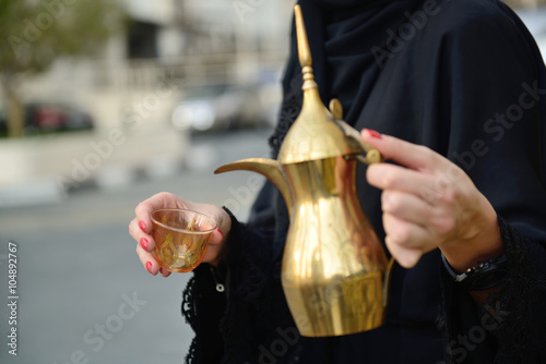 Emarati Arab  woman pouring tea