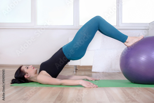 Girl doing abdominal muscles of her body.