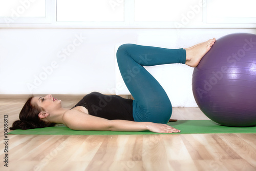 Girl doing exercises lying on the floor.