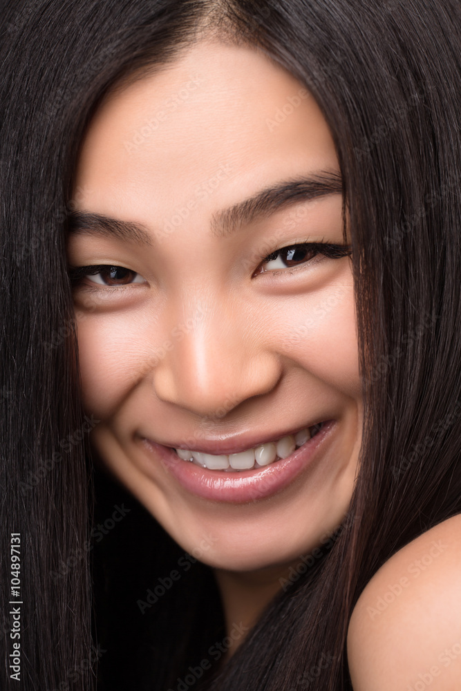 Close-up of smiling Asian woman in studio