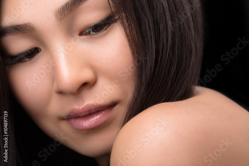Close-up of smiling Asian woman in studio