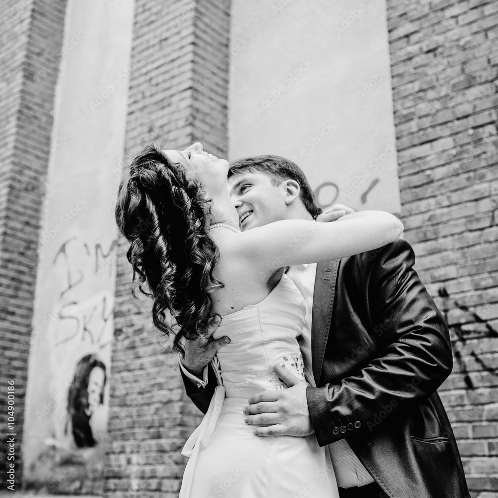 Happy newlywed romantic couple have fun outside b&w