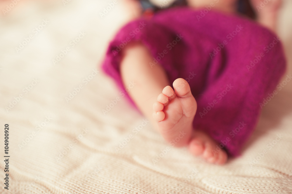 Cute baby feet closeup. Infant girl lying in bed. Bedtime. Childhood. Cute baby feet closeup. Infant girl lying in bed. Bedtime. Childhood.