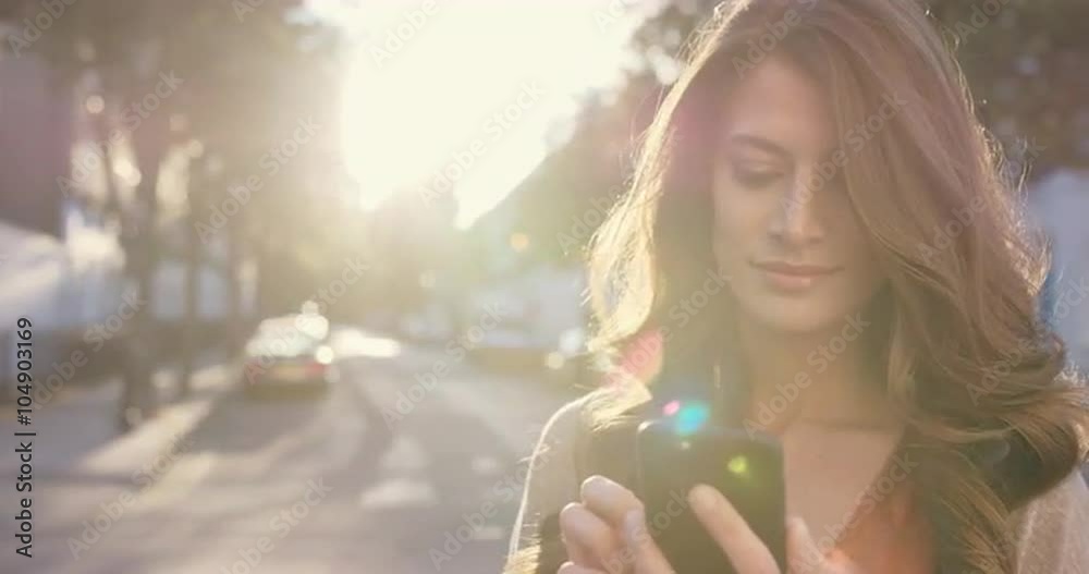 Beautiful woman using smart phone technology app in city 