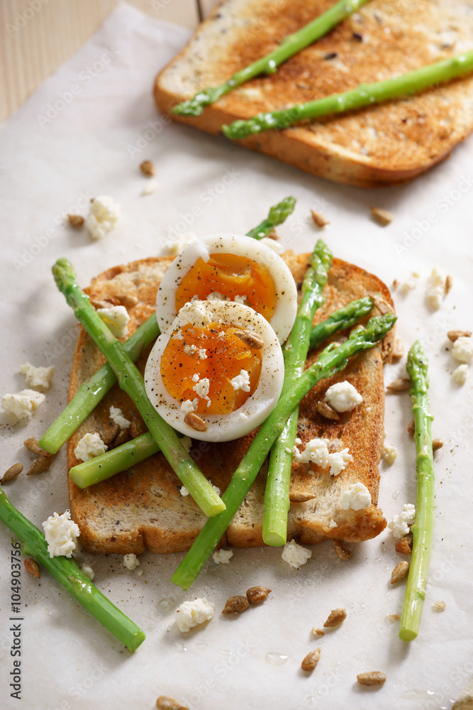 breakfast toast top with asparagus and soft boiled egg