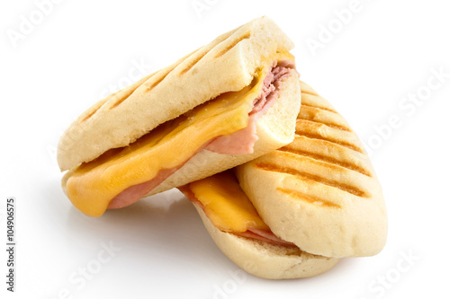 Cut cheese and ham toasted panini melt. Isolated on white. photo