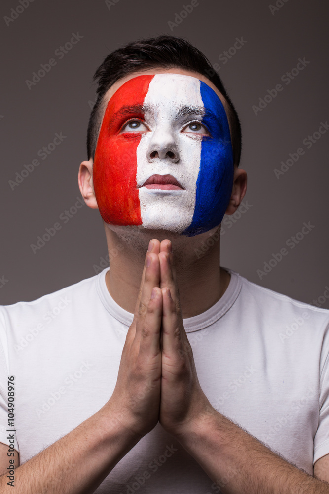 Pray France football fan in game  of France national  team look at sky. UEFA EURO 2016 football fans concept.