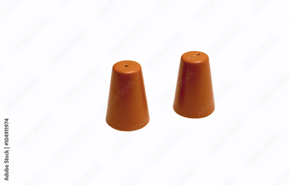 Salt and pepper shakers / the composition consists a salt and pepper shakers isolated on white background Salt and pepper shakers / the composition consists a salt and pepper shakers isolated on white background