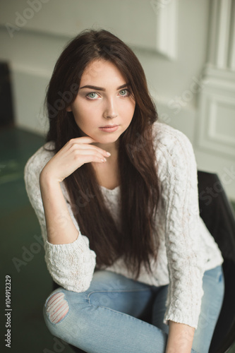 Portrait of a young lady in photostudio interior