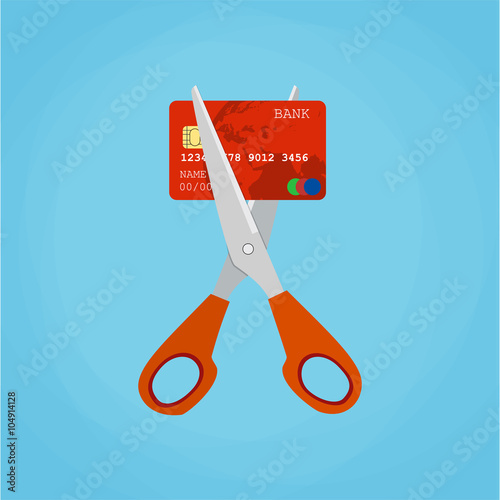 Red credit card cutting by the scissors.