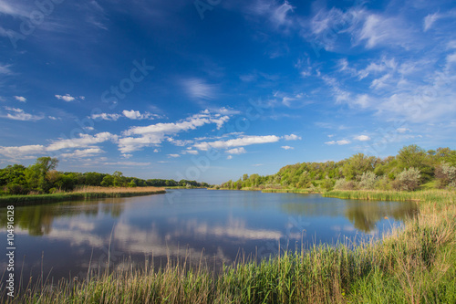 Fototapeta Naklejka Na Ścianę i Meble -  Landscape with lake, forest and blue sky