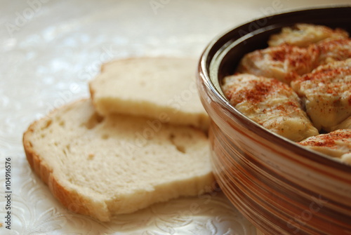 Sarma dish with slices of bread on white tablecloth