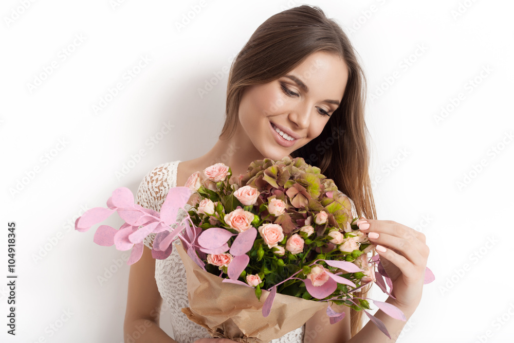 Young cute woman holding bunch of flowers