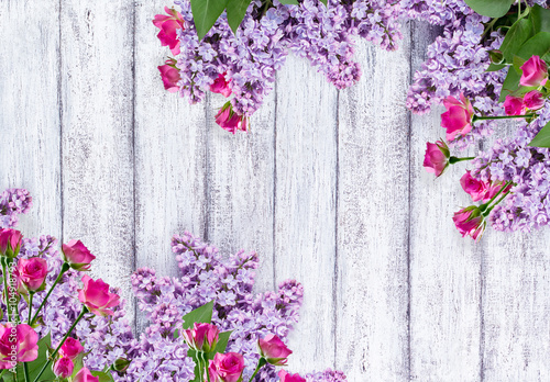 Lilac flowers with roses on shabby wooden planks