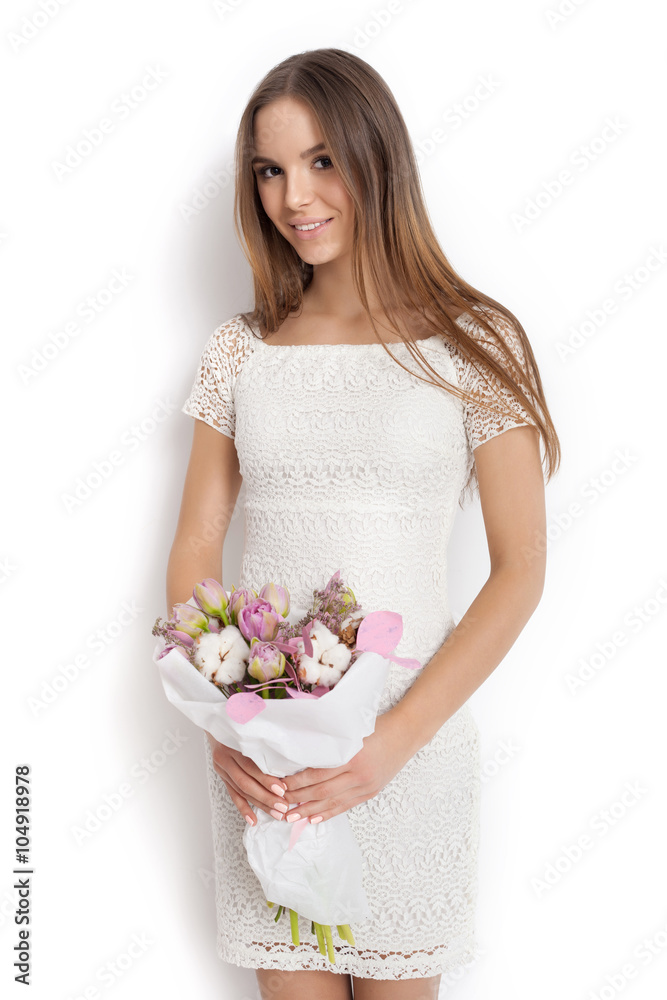 Young cute woman holding bunch of flowers