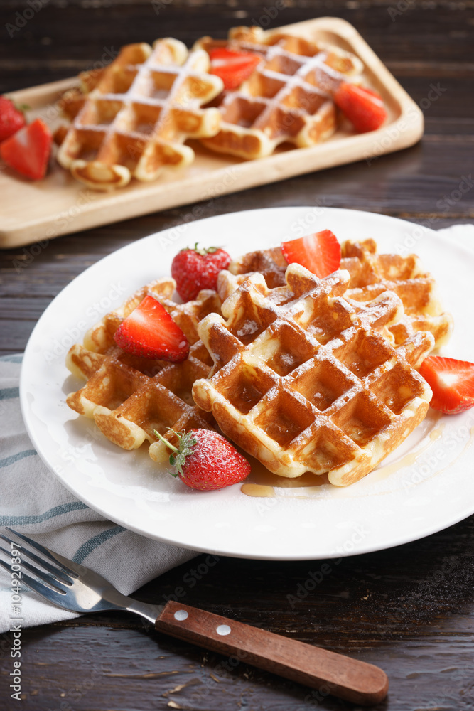 Homemade waffles with syrup and strawberry. Homemade waffles with syrup and strawberry.