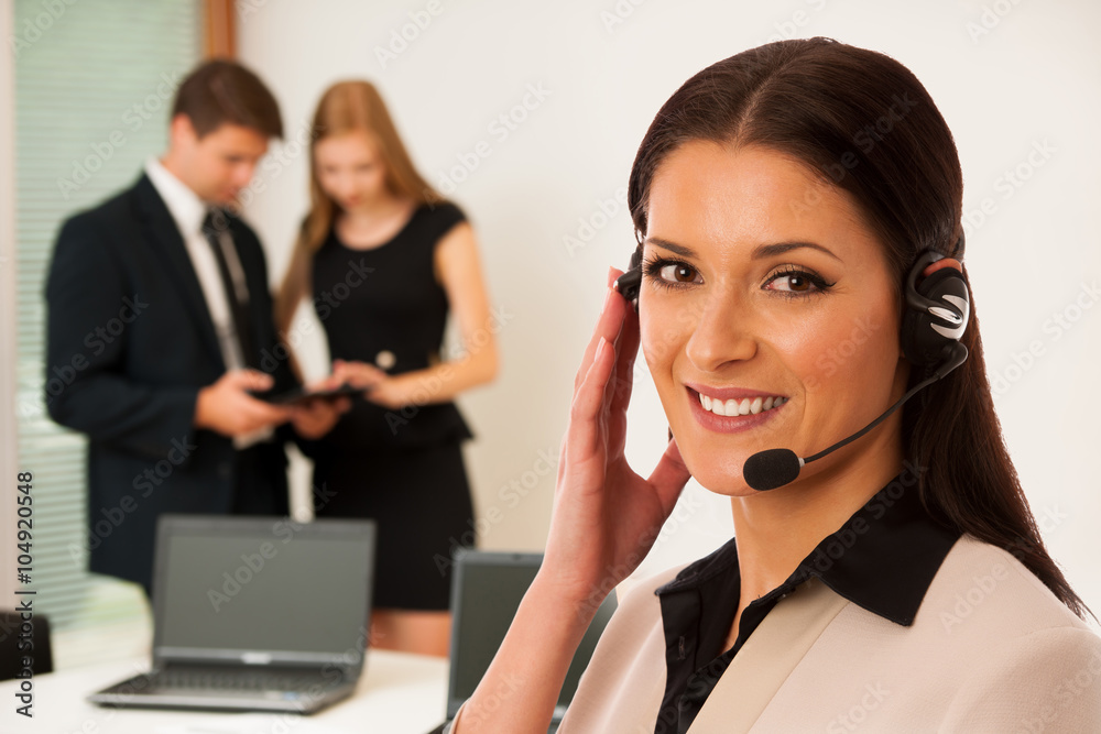 Business woman - secretarry standing in first plain with cowork Business woman - secretarry standing in first plain with cowork
