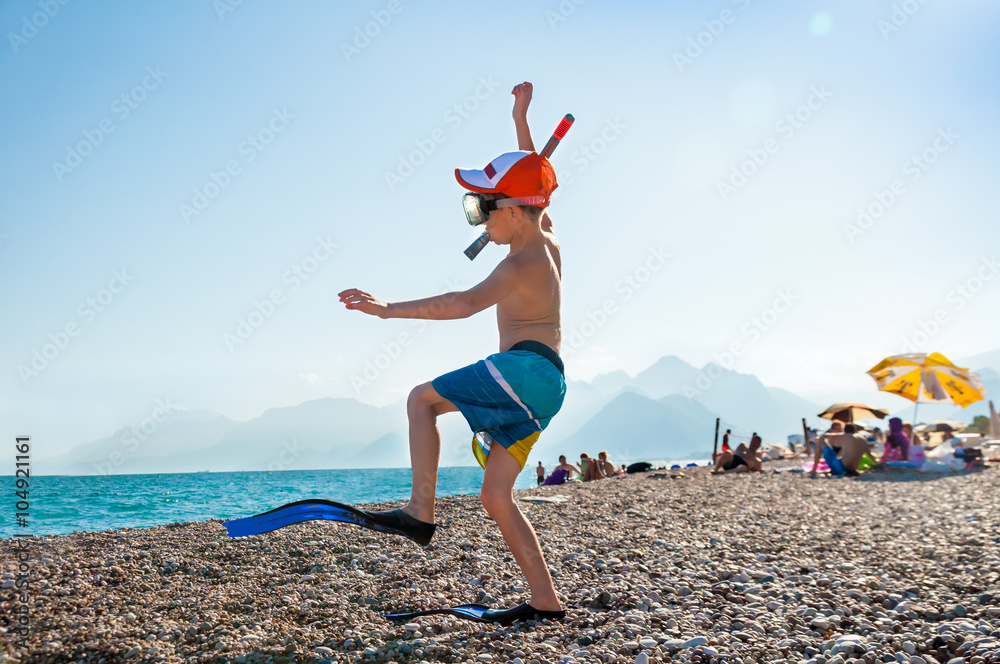 Fototapeta premium A child in flippers and snorkel