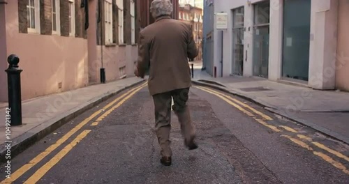 Contemporary funky elderly man street dancer dancing freestyle in the city