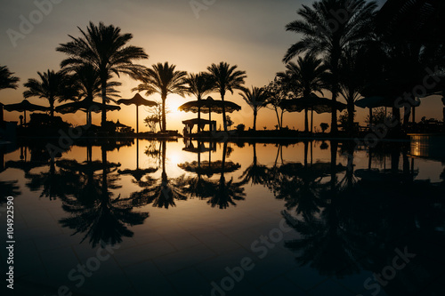 Fototapeta Naklejka Na Ścianę i Meble -  Beautiful sunset at a beach resort in tropics with palms and wat