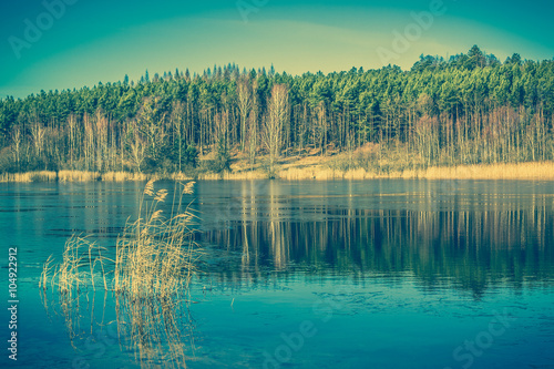 Fototapeta Naklejka Na Ścianę i Meble -  Vintage landscape of lake with calm surface.
