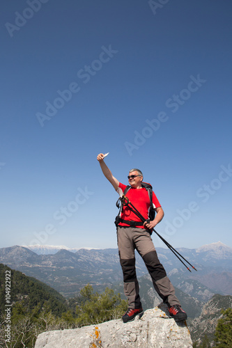 Hiker taking selfie on top of the mountain.