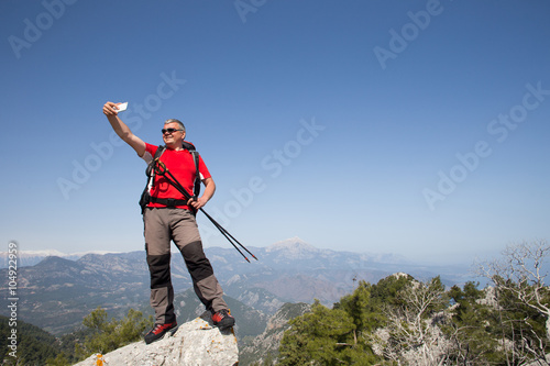 Hiker taking selfie on top of the mountain.