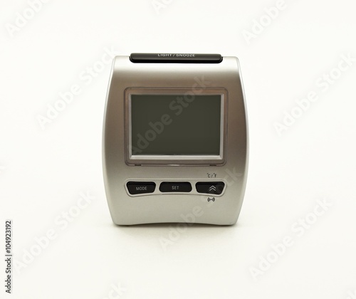 silver digital alarm clock on a white background