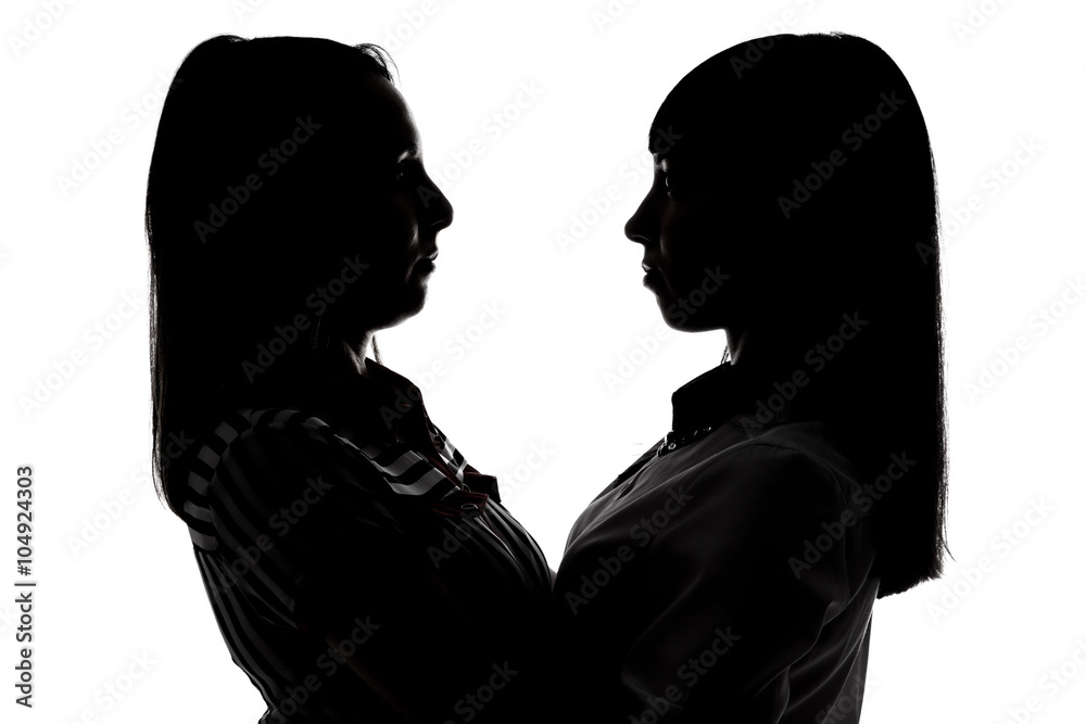 Silhouette of women looking at each other 
