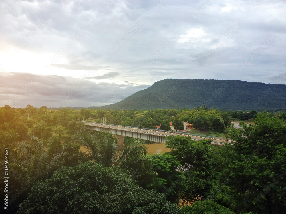 Sunrise on forest mountain and Bridge over the river Sunrise on forest mountain and Bridge over the river
