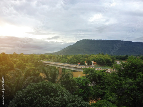 Sunrise on forest mountain and Bridge over the river