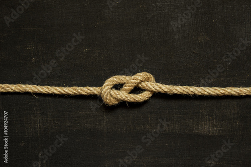Eight knot on a black background. Photo of a series of nautical knots.