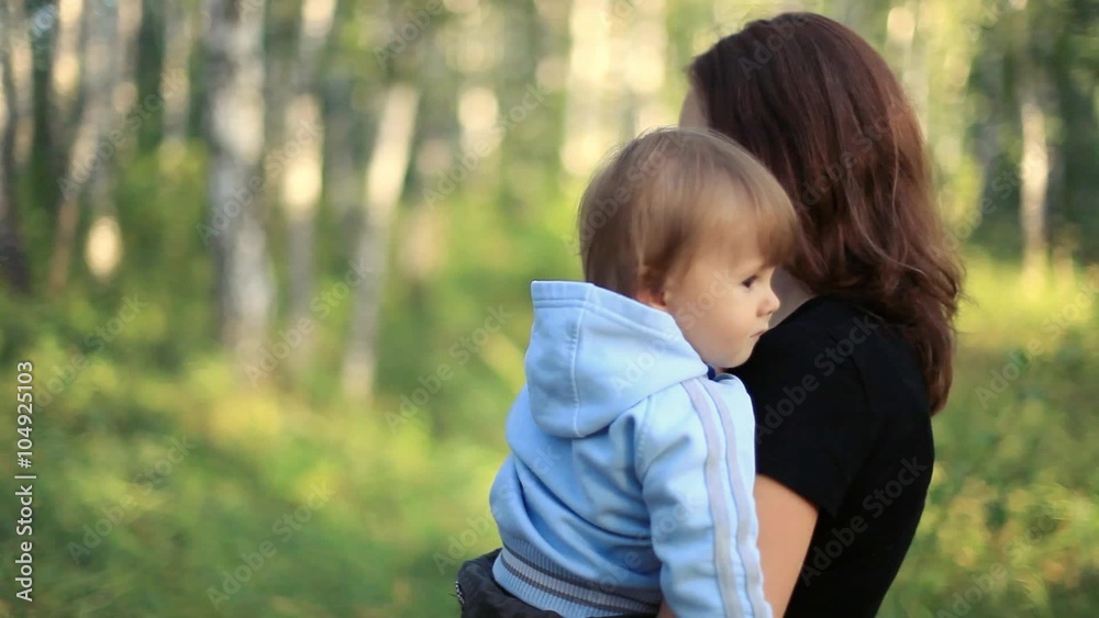 Happy cheerful smiling mother and son child walks outdoors in park. 1920x1080 Happy cheerful smiling mother and son child walks outdoors in park. 1920x1080