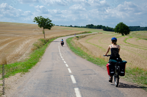 Картината върху платно Burgundy, France - CIRCA August, 2015 - Biker with panniers cycling near Noyers