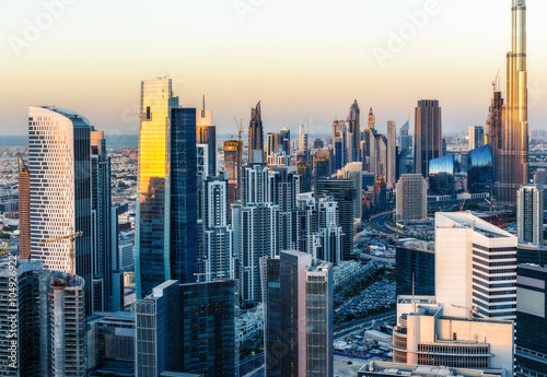 Beautiful modern city architecture at sunset. View of Dubai's business bay towers.