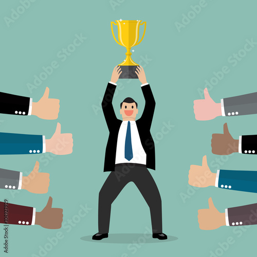 Crowd praise businessman holding up a winning trophy