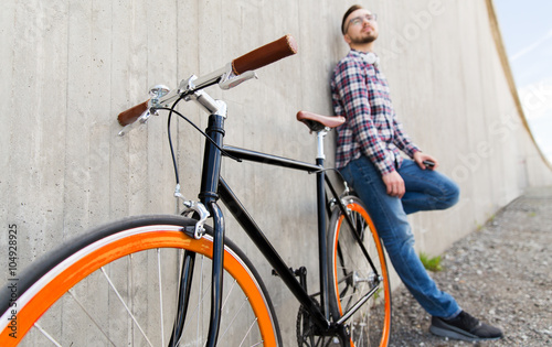 close up of hipster fixed gear bike and man