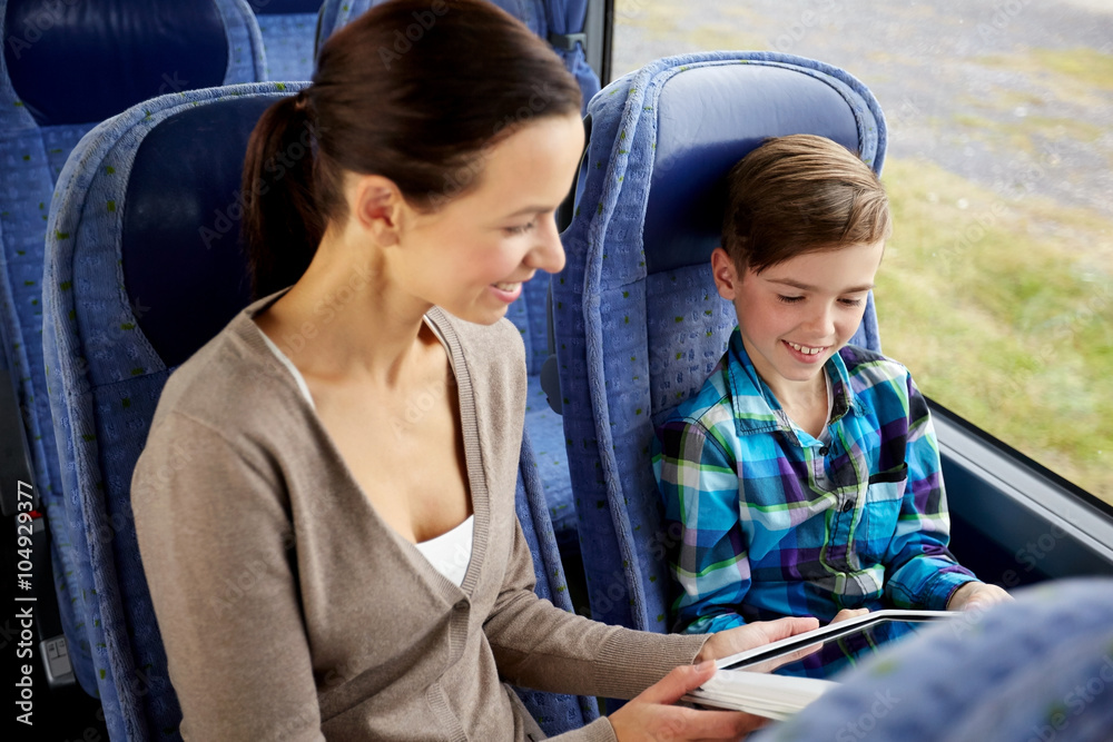 happy family with tablet pc sitting in travel bus happy family with tablet pc sitting in travel bus